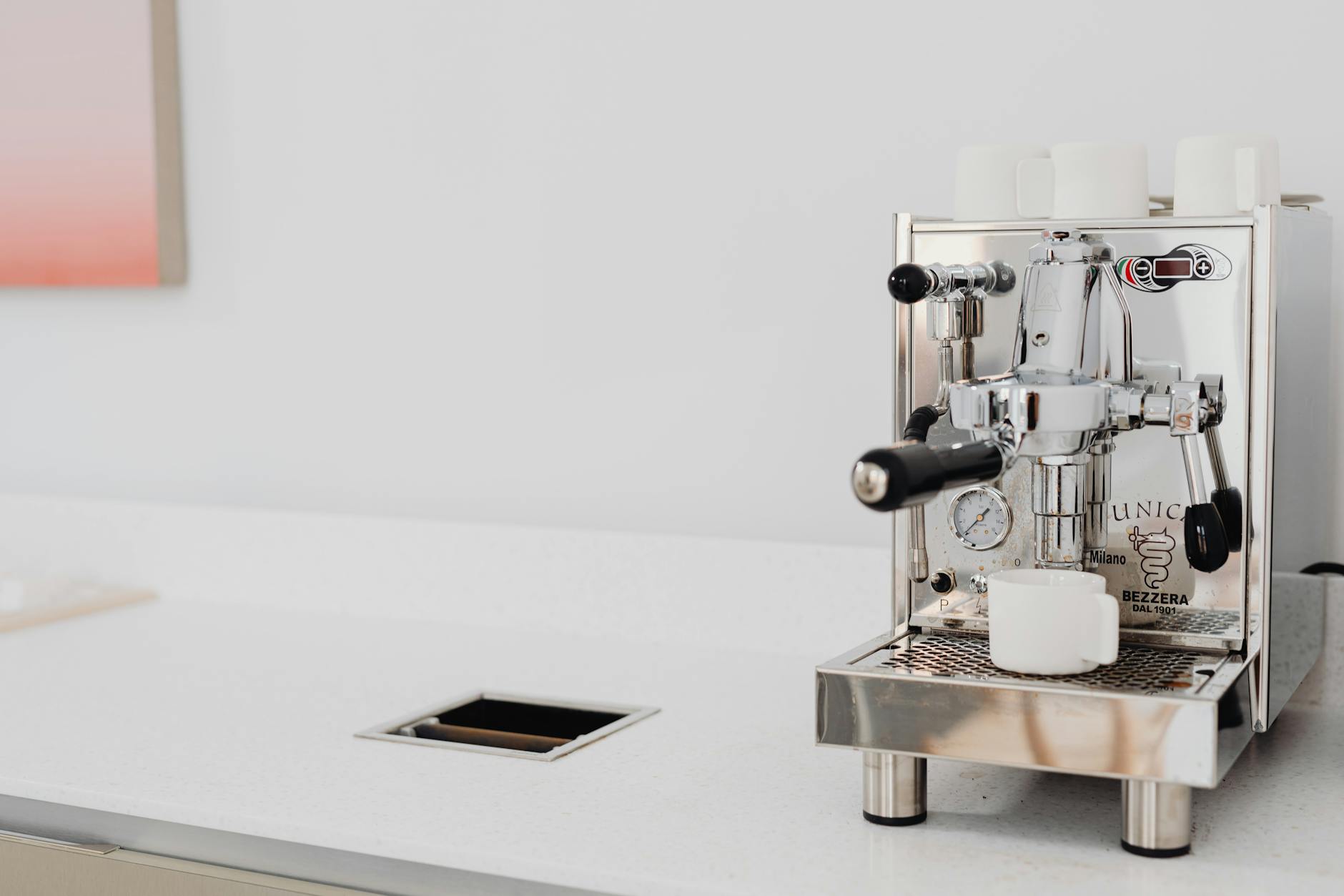 Sleek espresso machine brewing coffee in a minimalist kitchen
