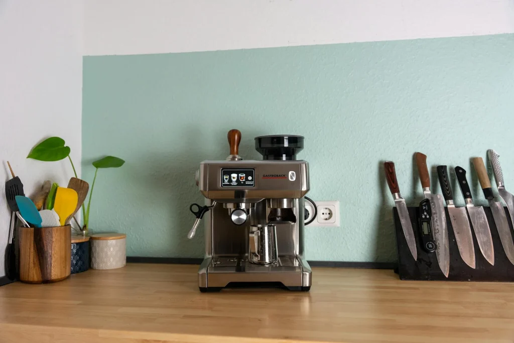Modern bean-to-cup coffee machine on a wooden kitchen counter