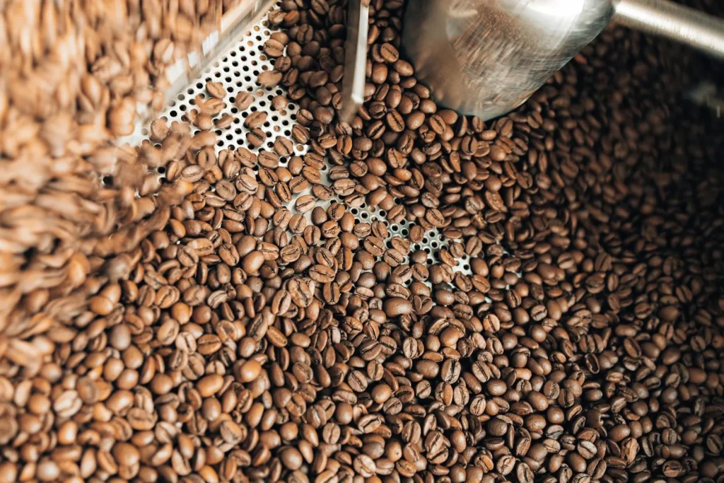 Freshly roasted coffee beans inside a commercial coffee roasting machine