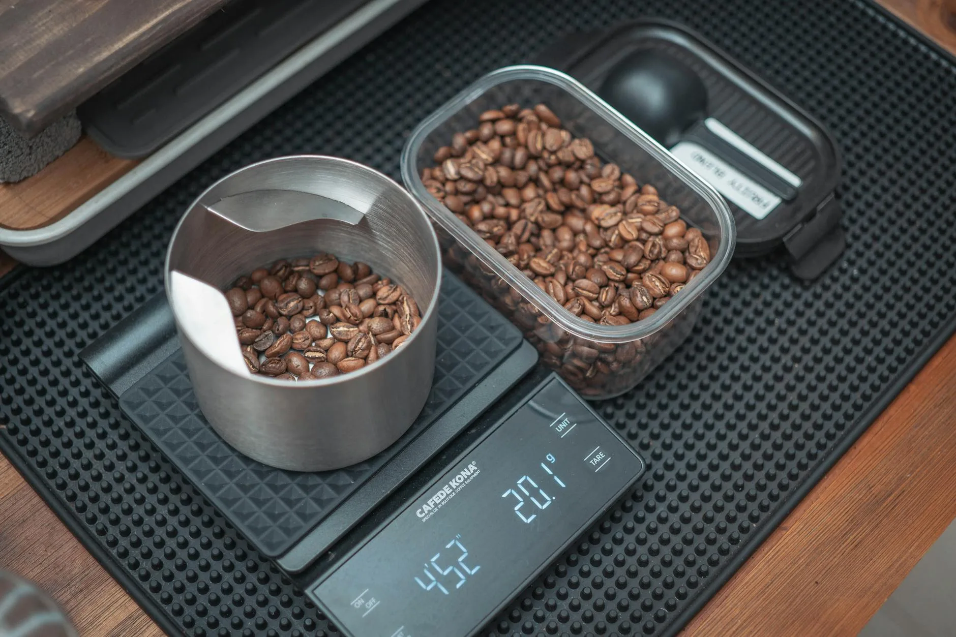 Fresh coffee beans being weighed on a precision scale