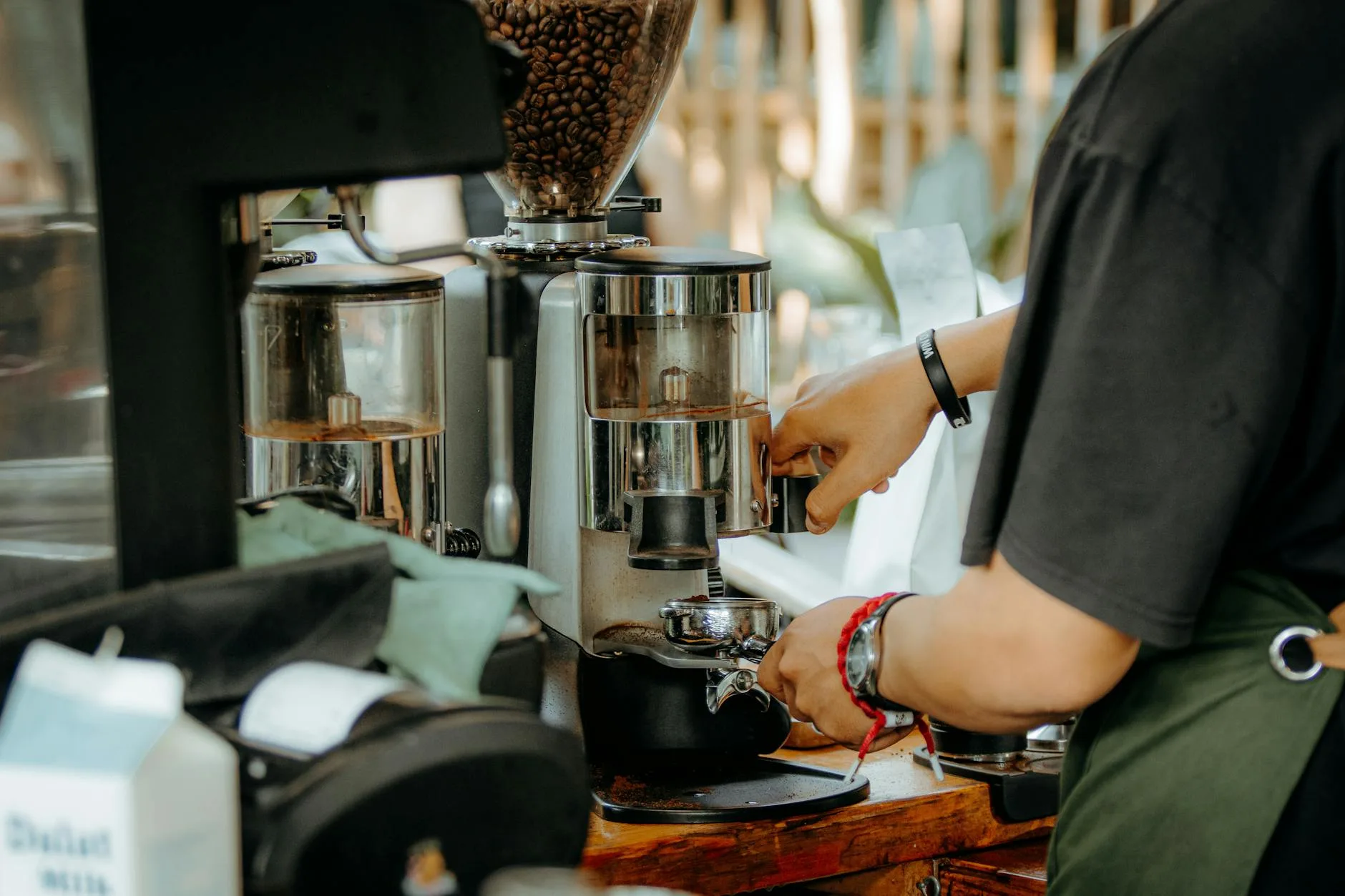 Coffee grinder with fresh beans being prepared for espresso brewing