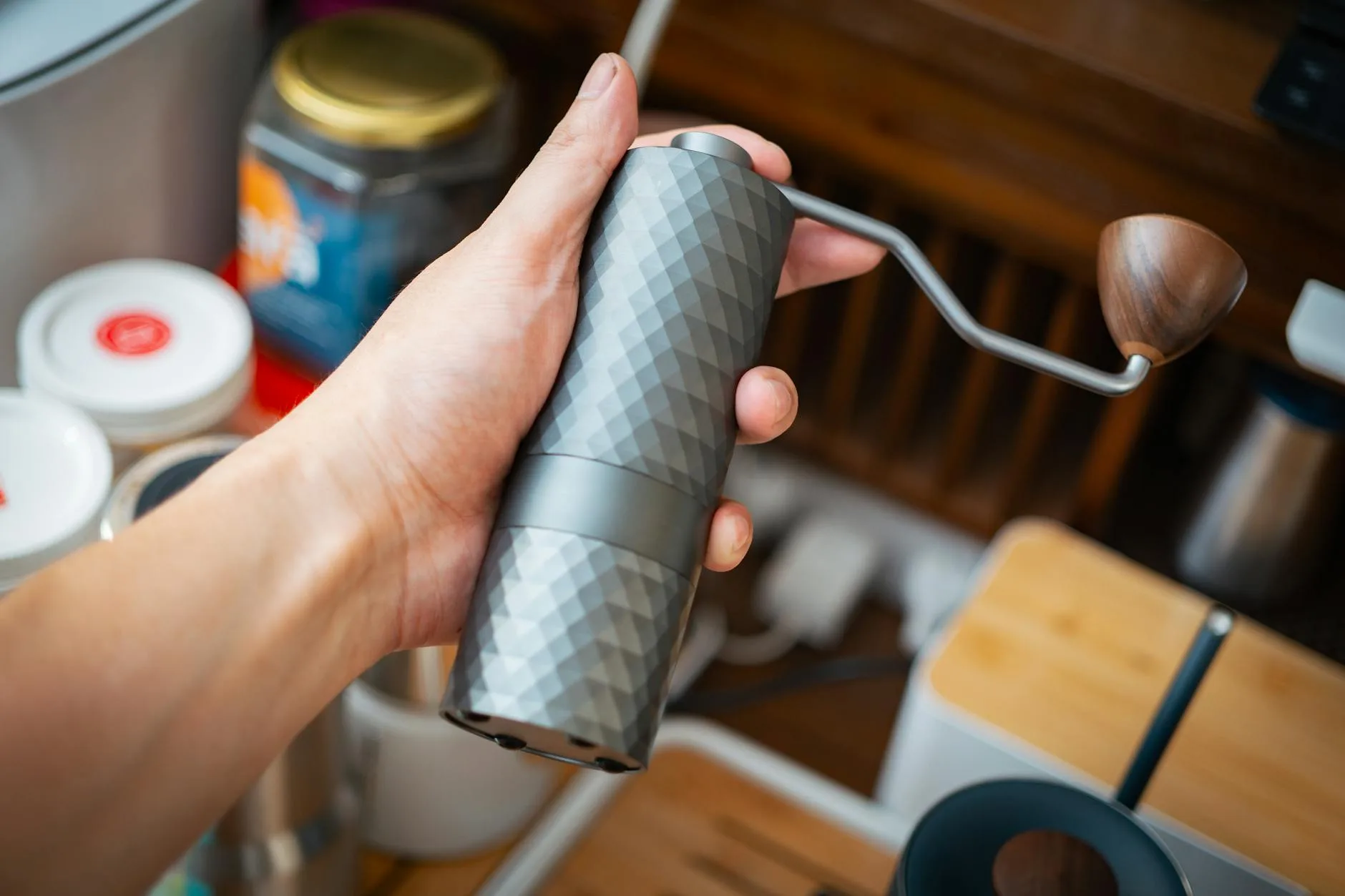 Coffee grinder with freshly ground beans on kitchen counter