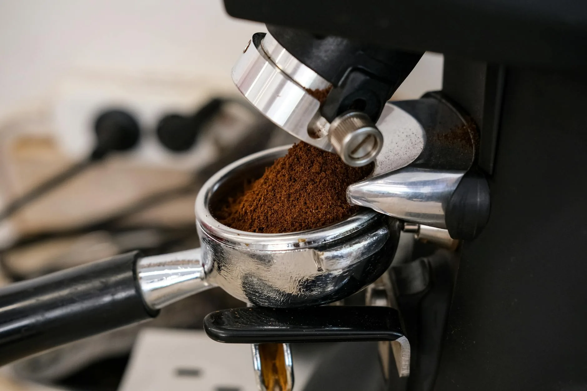 Fresh coffee grounds being dispensed into a portafilter