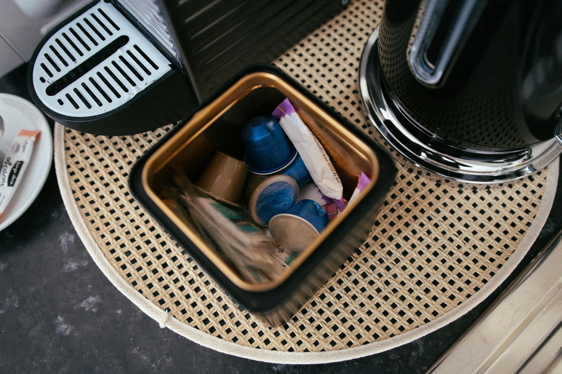 Colourful coffee pods and capsules beside a machine