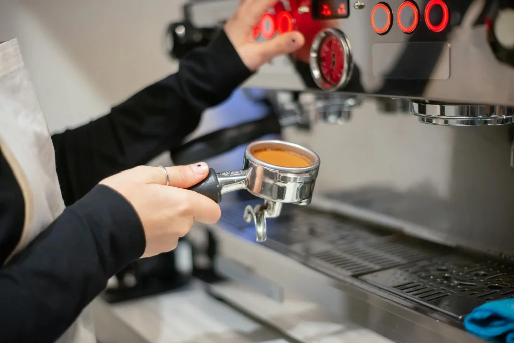 Espresso machine pulling a shot of coffee through a portafilter