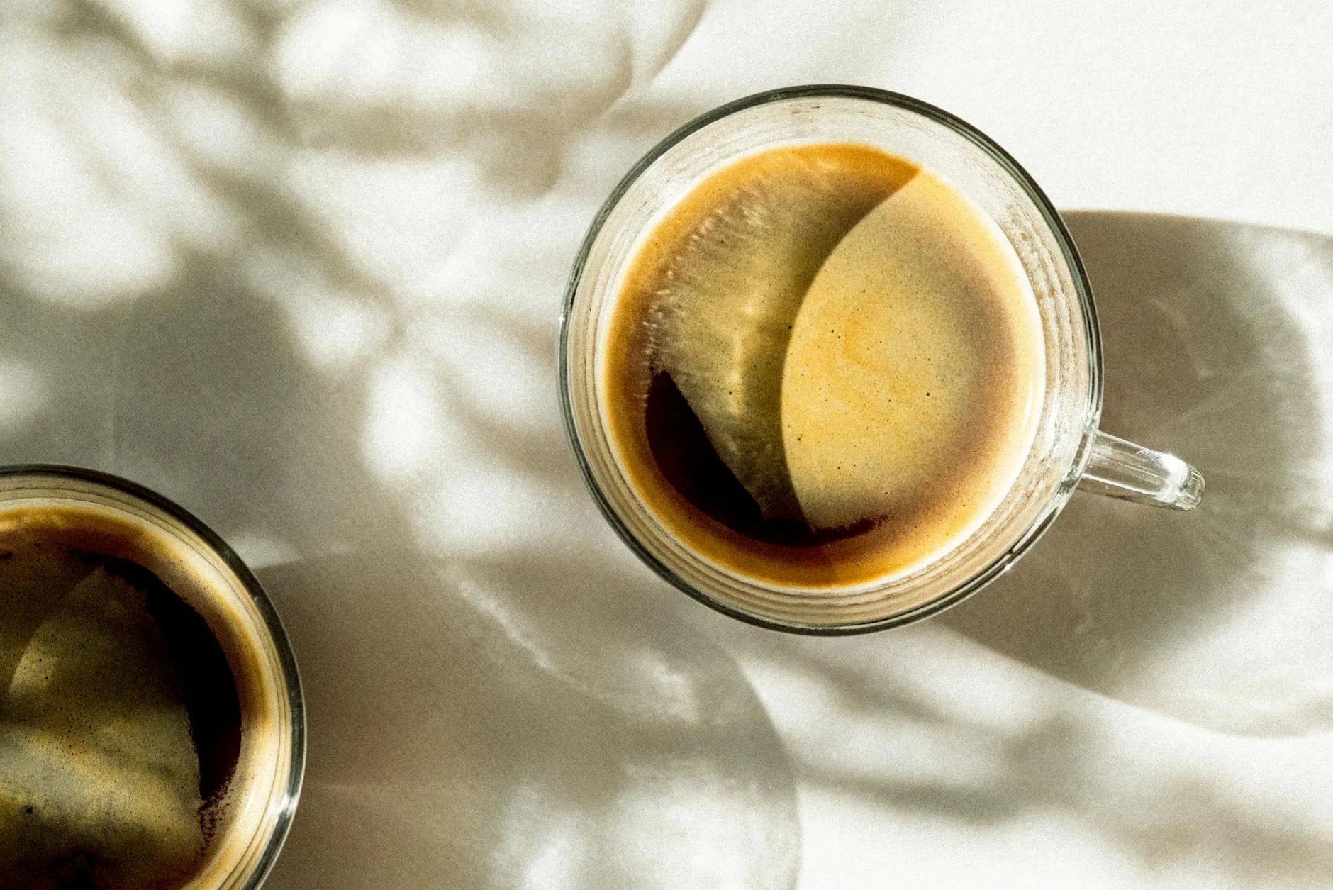 Double espresso shot with rich crema in a glass cup
