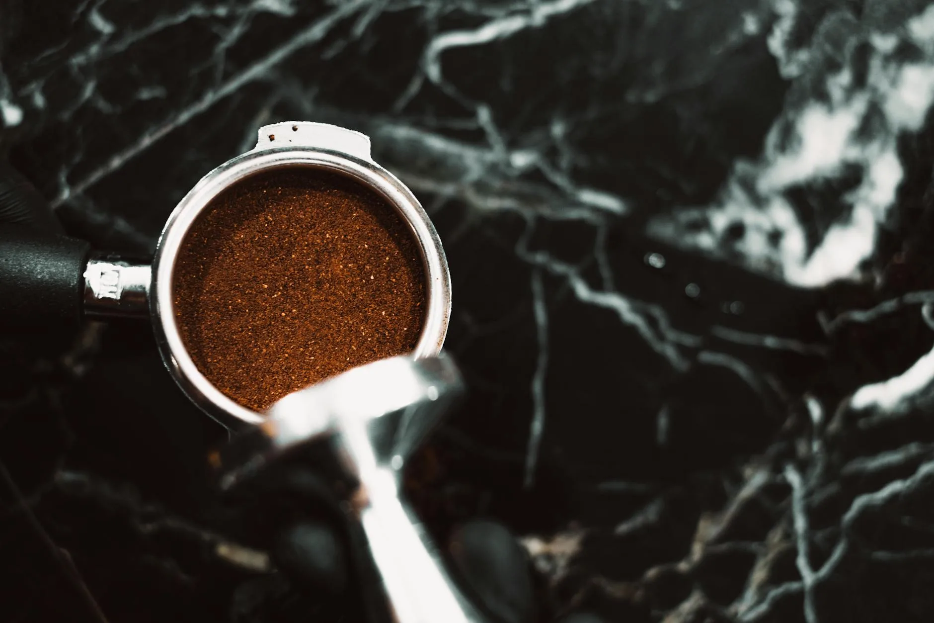 Espresso shot pulling into a cup with golden crema forming