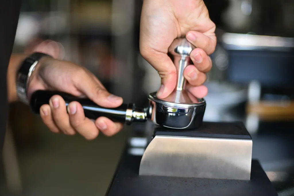 Coffee tamper on an espresso portafilter