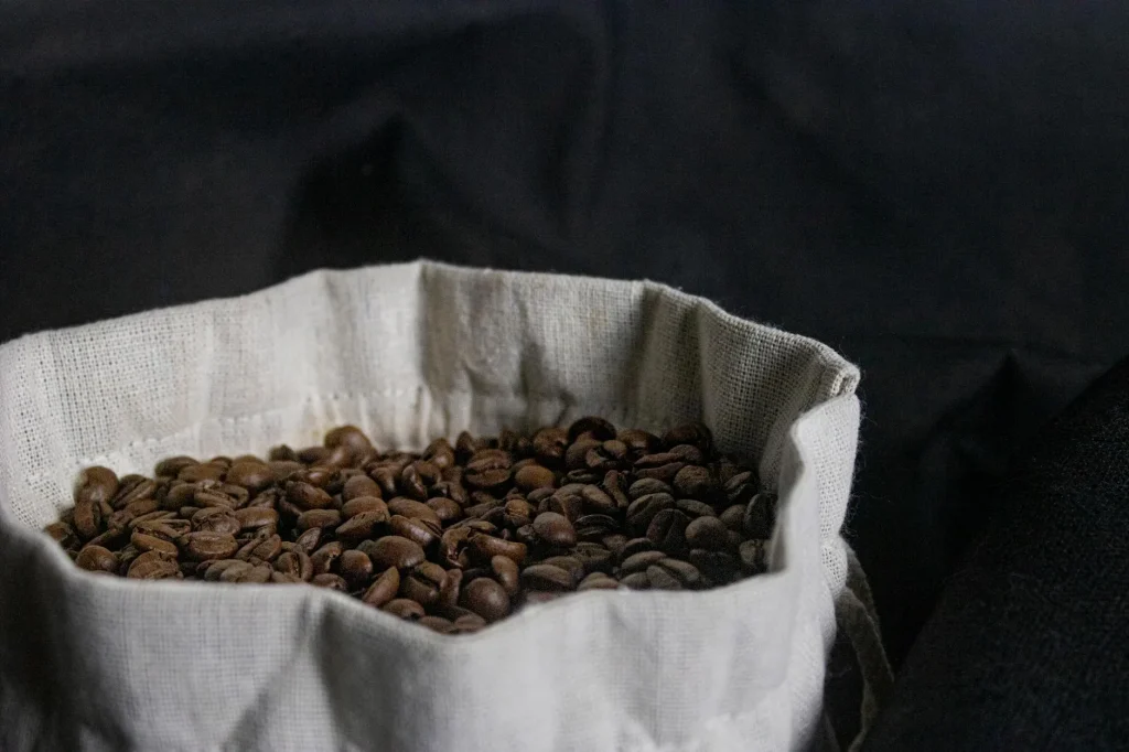 Fresh roasted coffee beans spilling from a bag