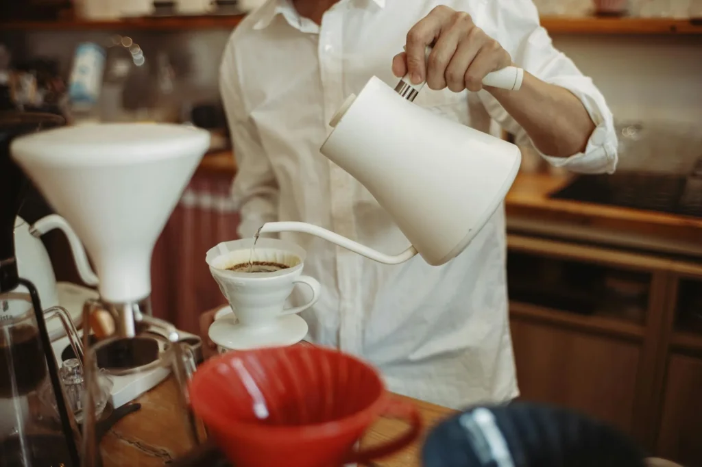Gooseneck kettle pouring water into a pour-over coffee dripper