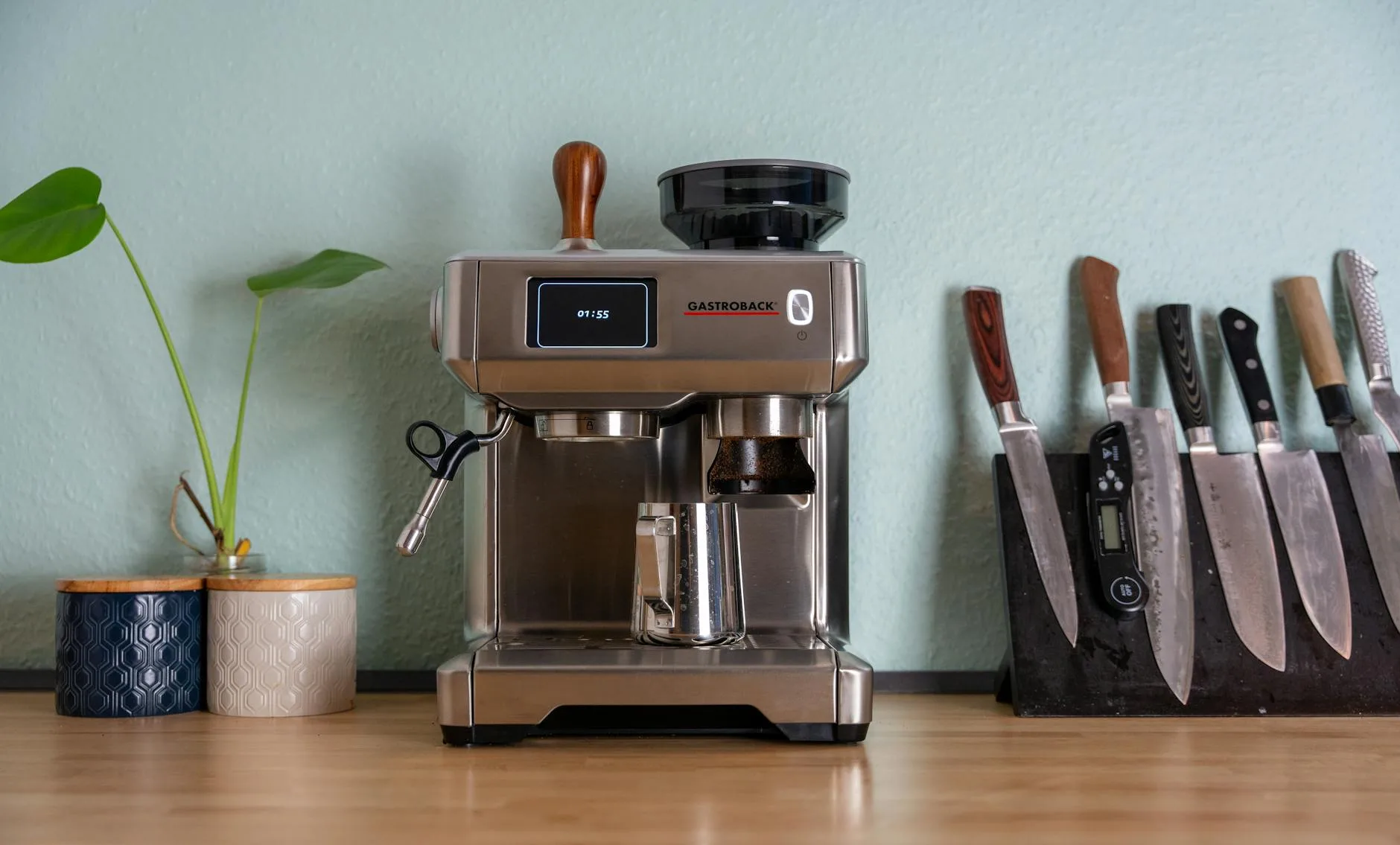 Home espresso machine on a kitchen counter with coffee accessories