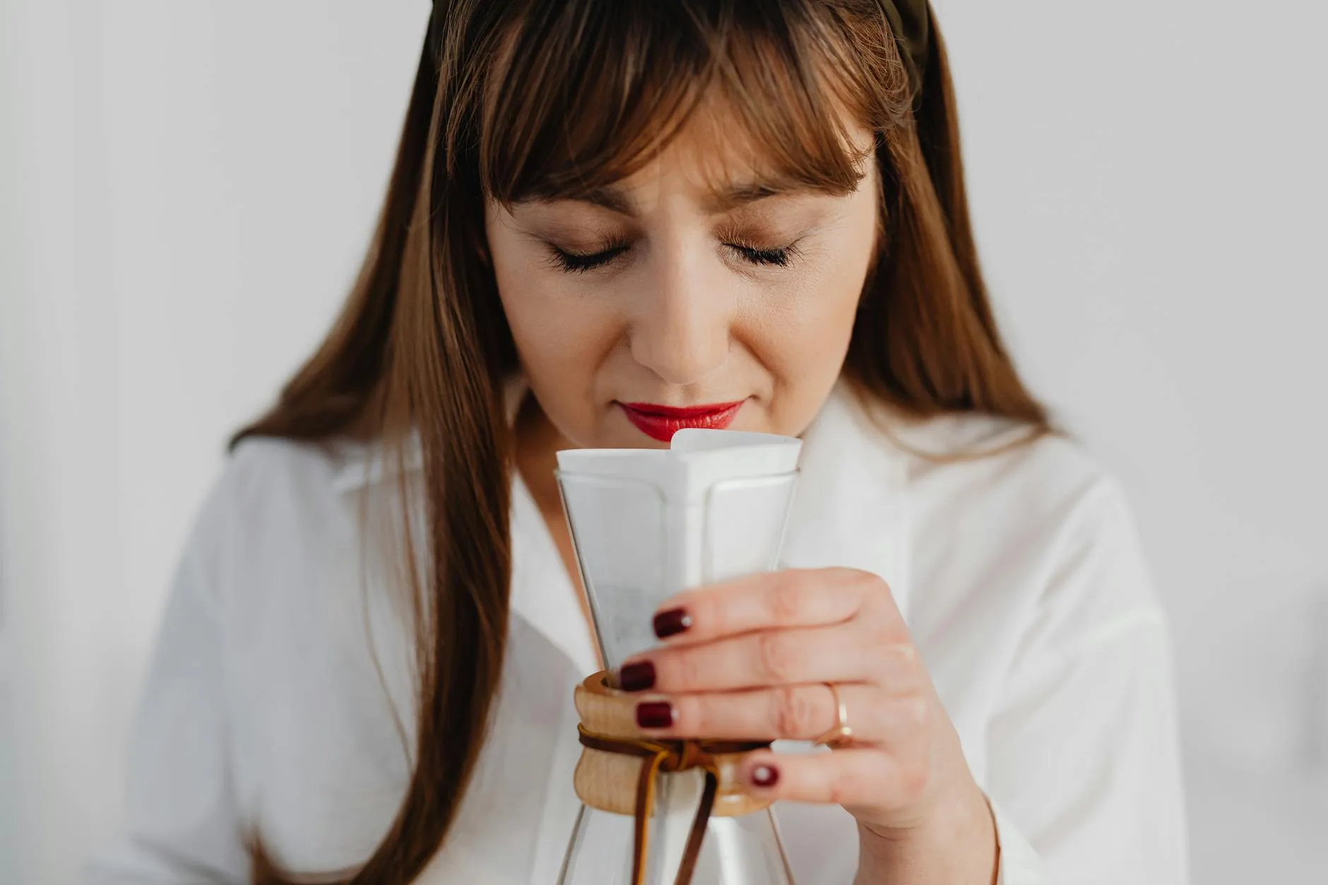 Person smelling coffee aroma during a cupping session