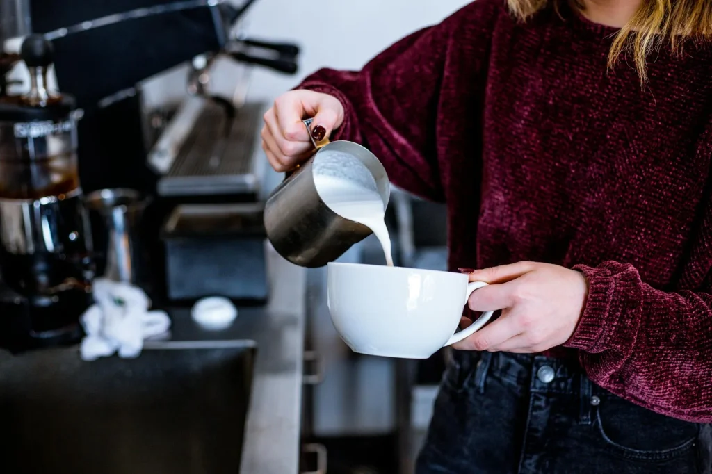 Espresso shot with latte art being poured at home