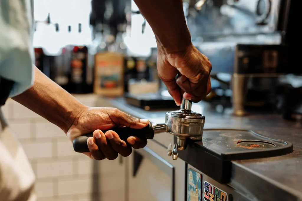 Espresso machine brewing coffee with steam and portafilter