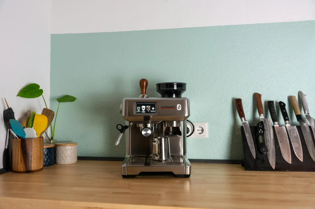 Coffee grinder with beans on a kitchen counter