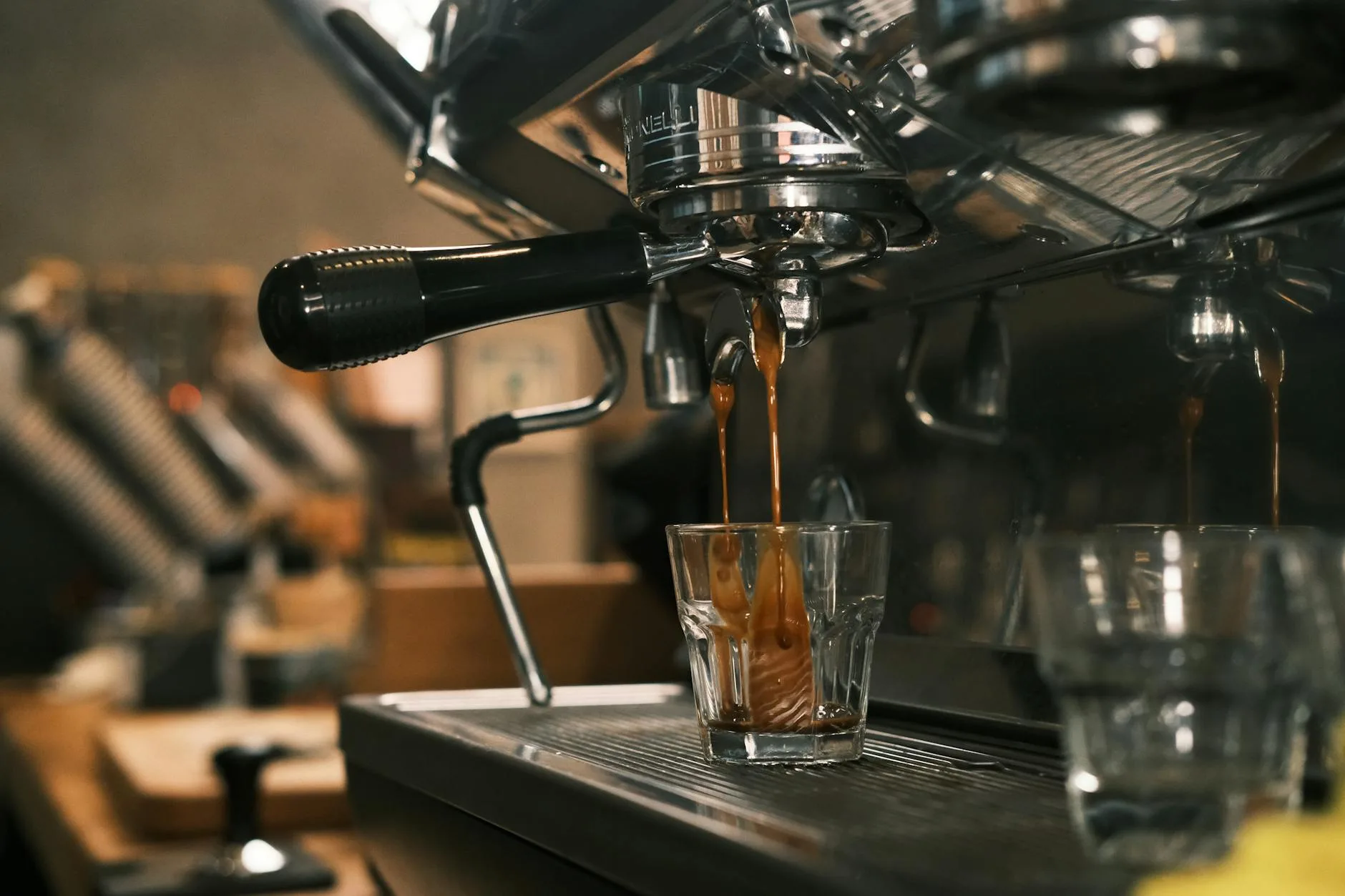 Espresso shot pouring into a glass showing rich crema