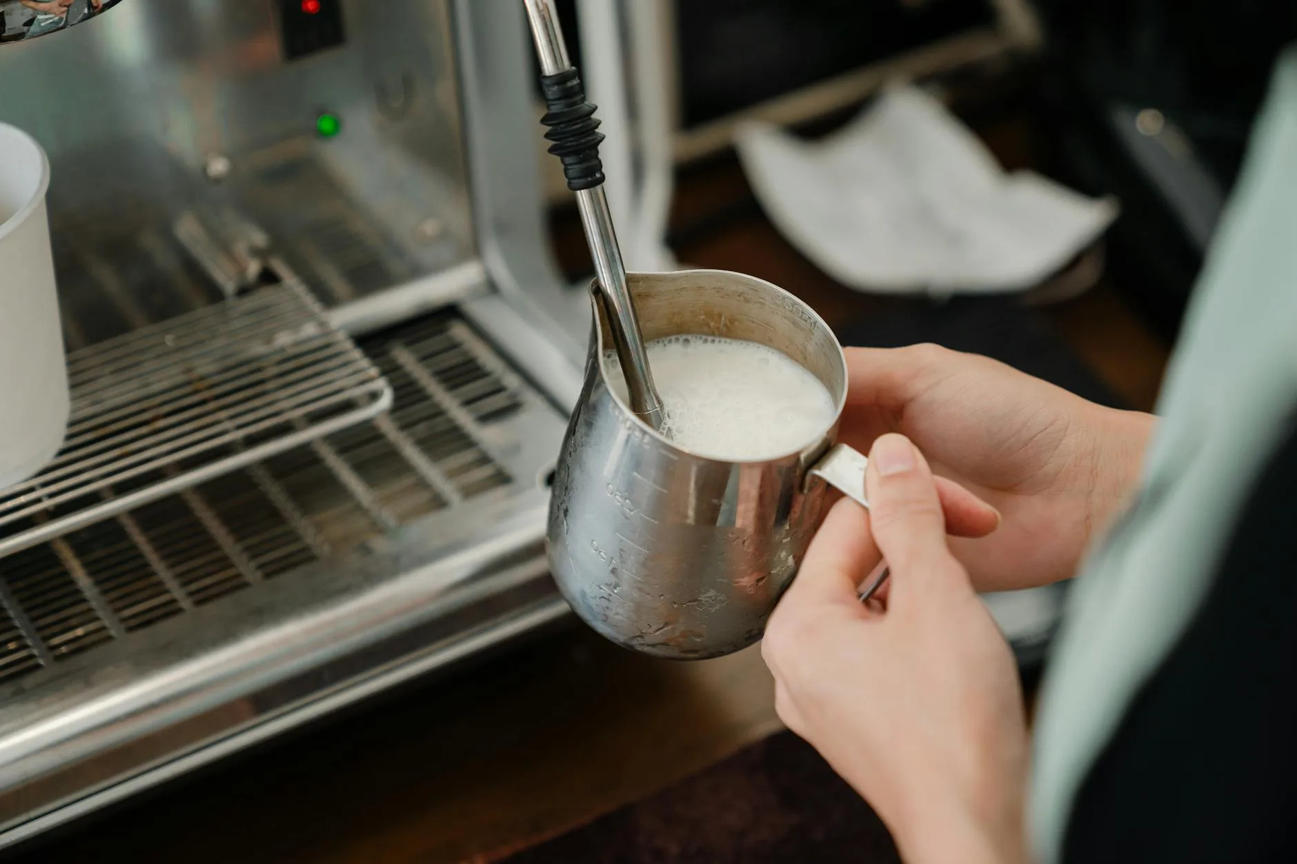 Steam wand frothing milk for a cappuccino