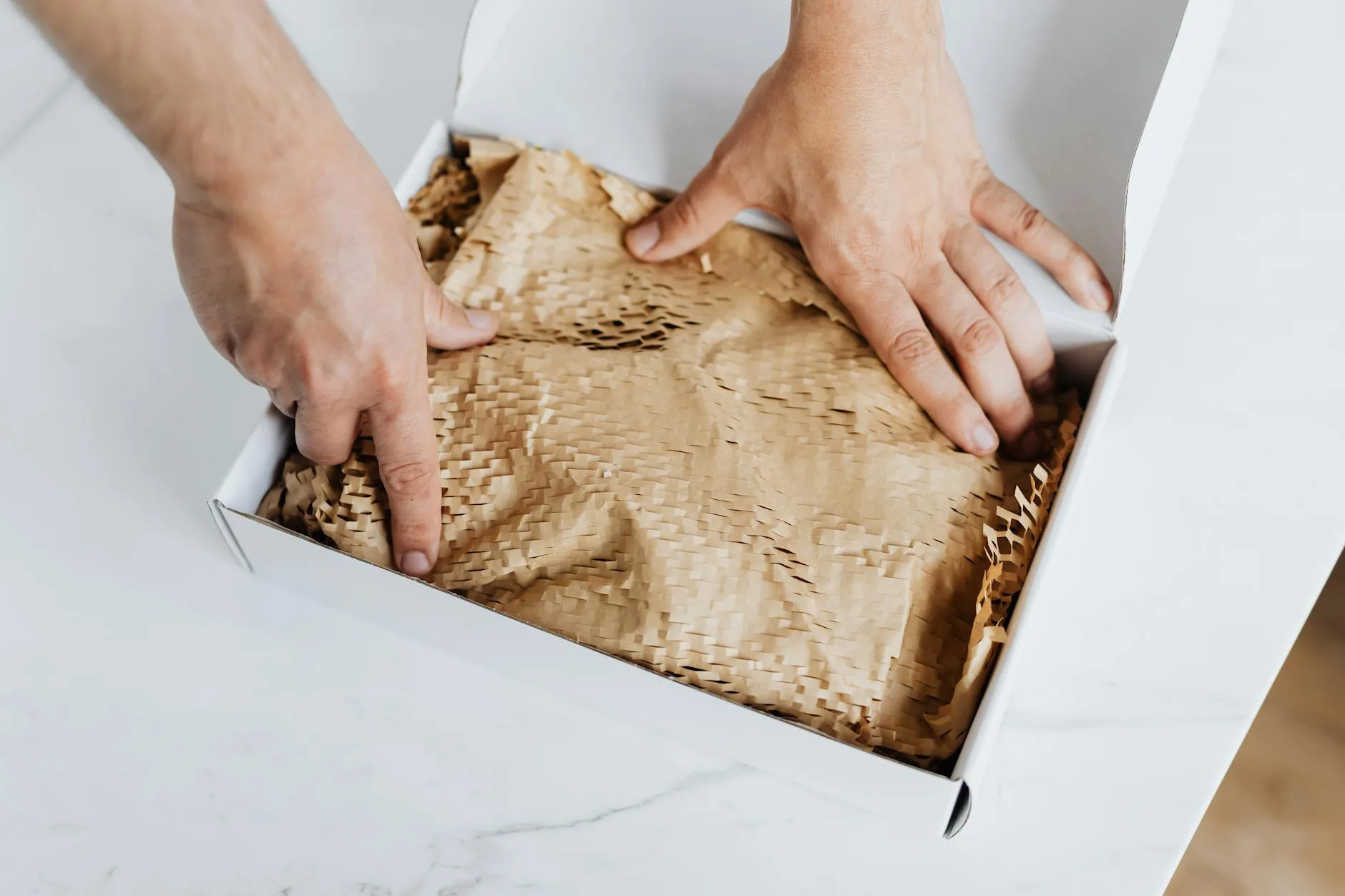 Person opening a coffee subscription delivery at home