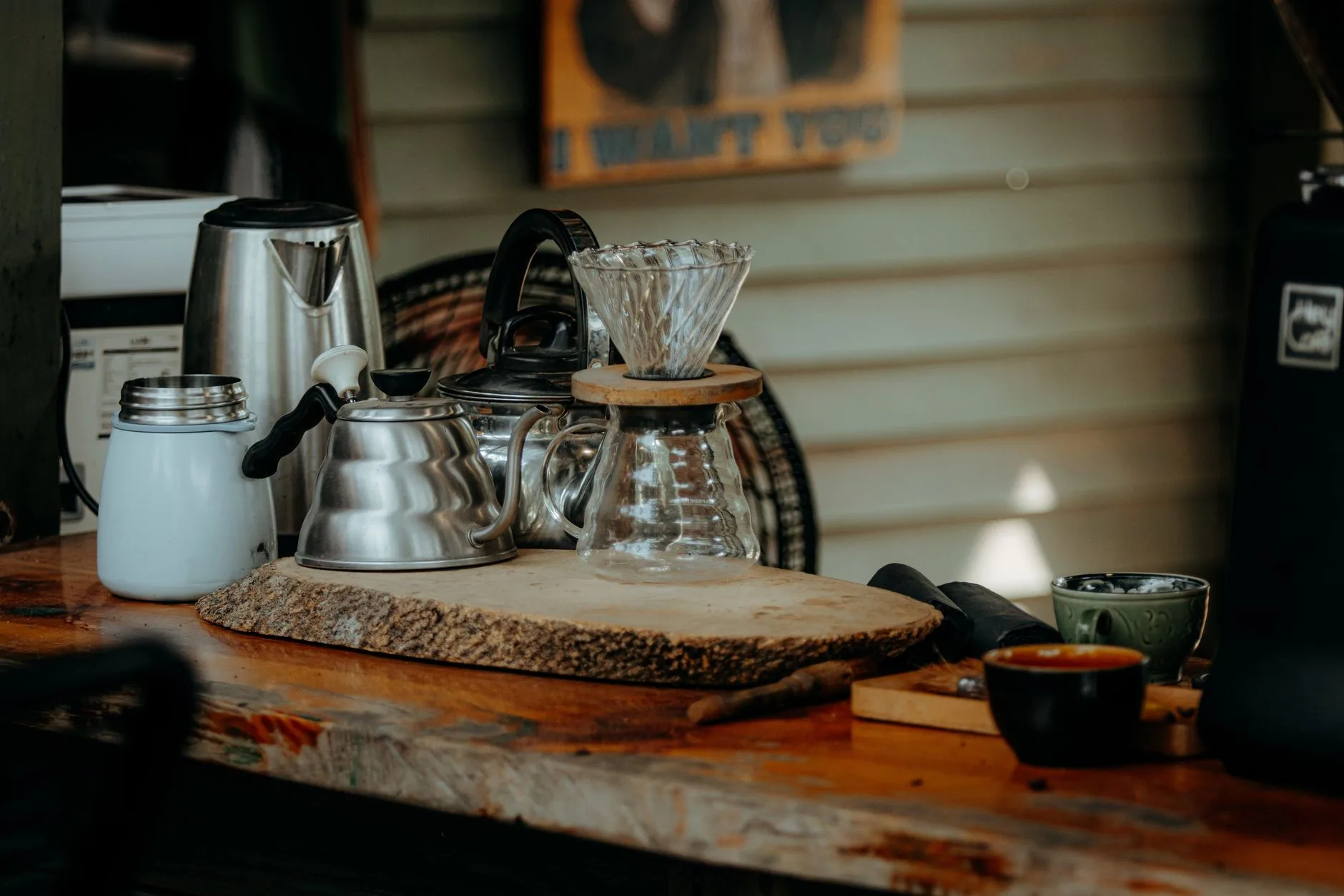 Coffee kettle and thermometer beside a pour-over setup