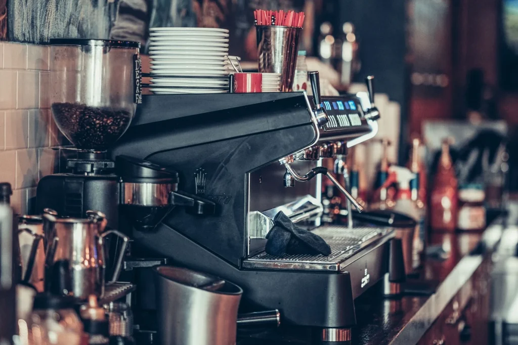 Clean coffee station with espresso machine and drip tray on a kitchen counter