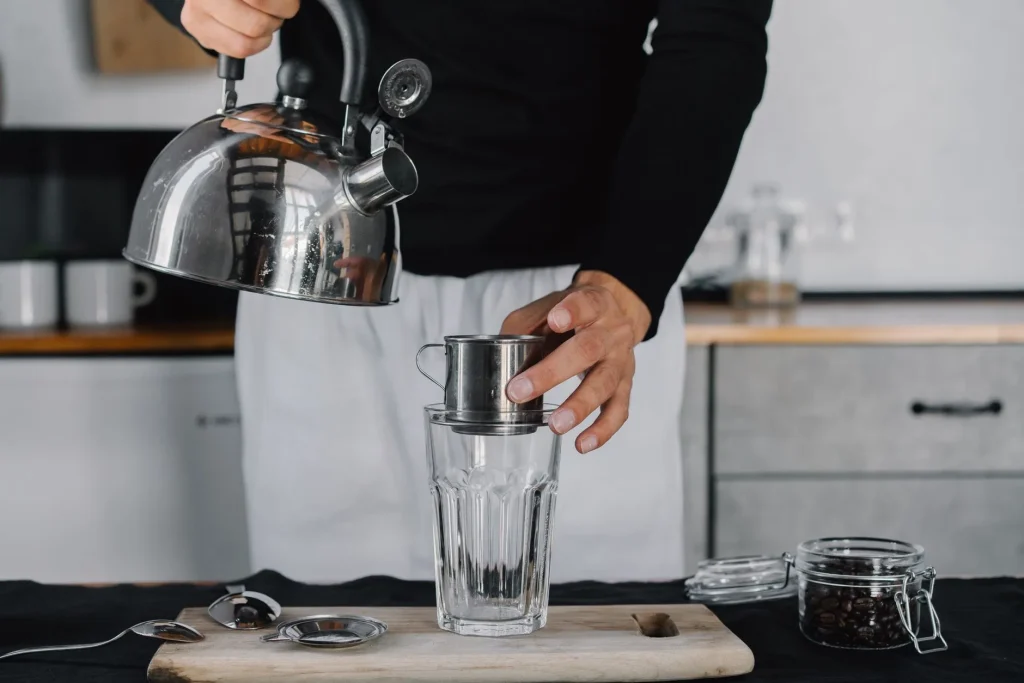 Barista checking coffee temperature while brewing