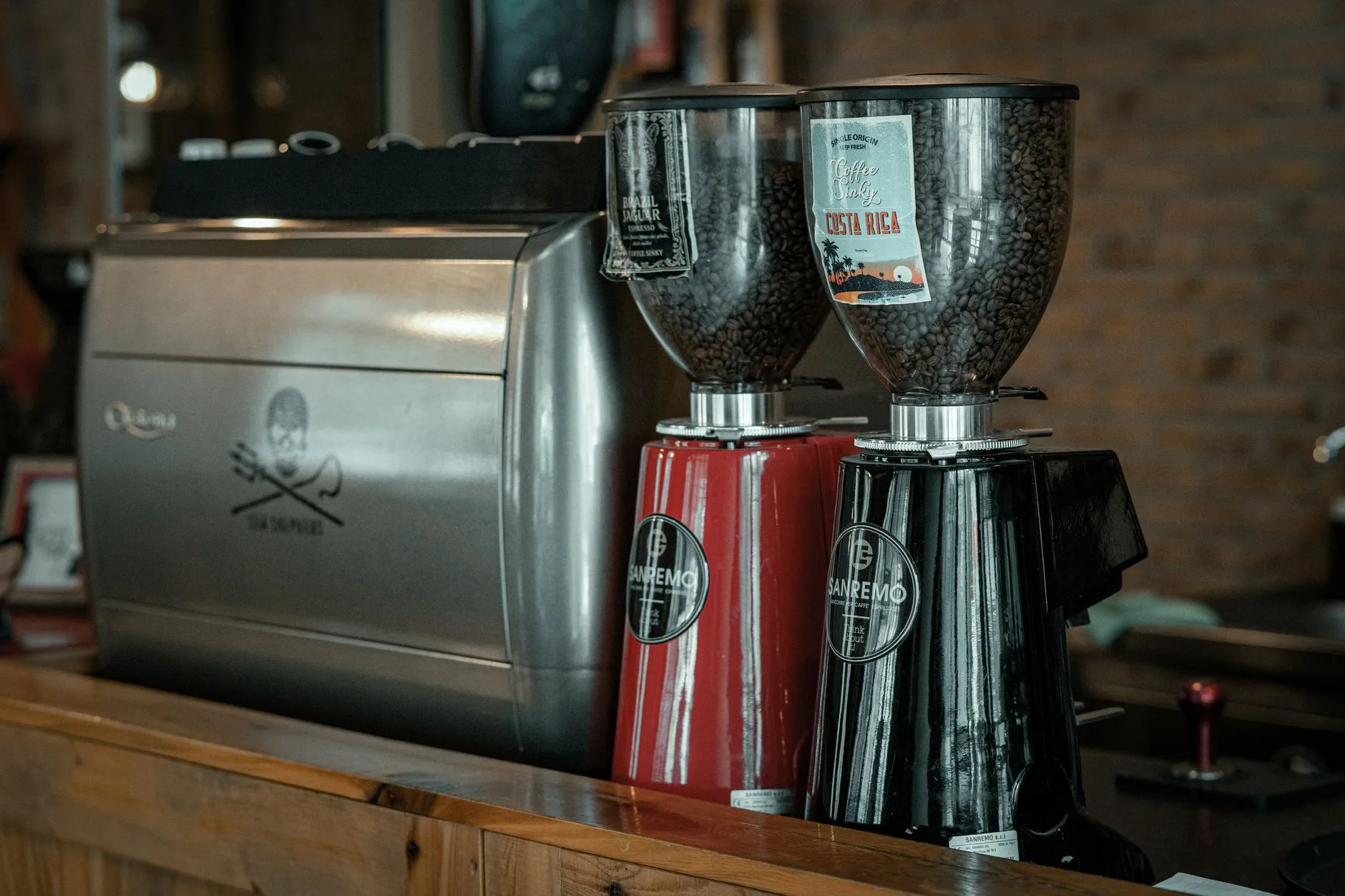 Coffee beans beside an espresso grinder