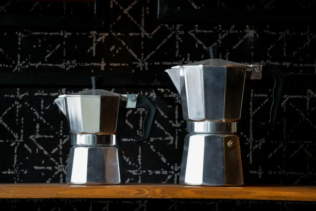 Moka pot brewing coffee on a kitchen hob