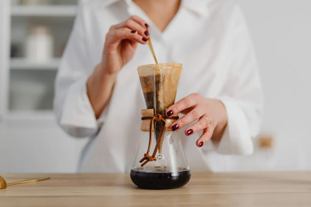 Chemex glass brewer with filter coffee in a kitchen
