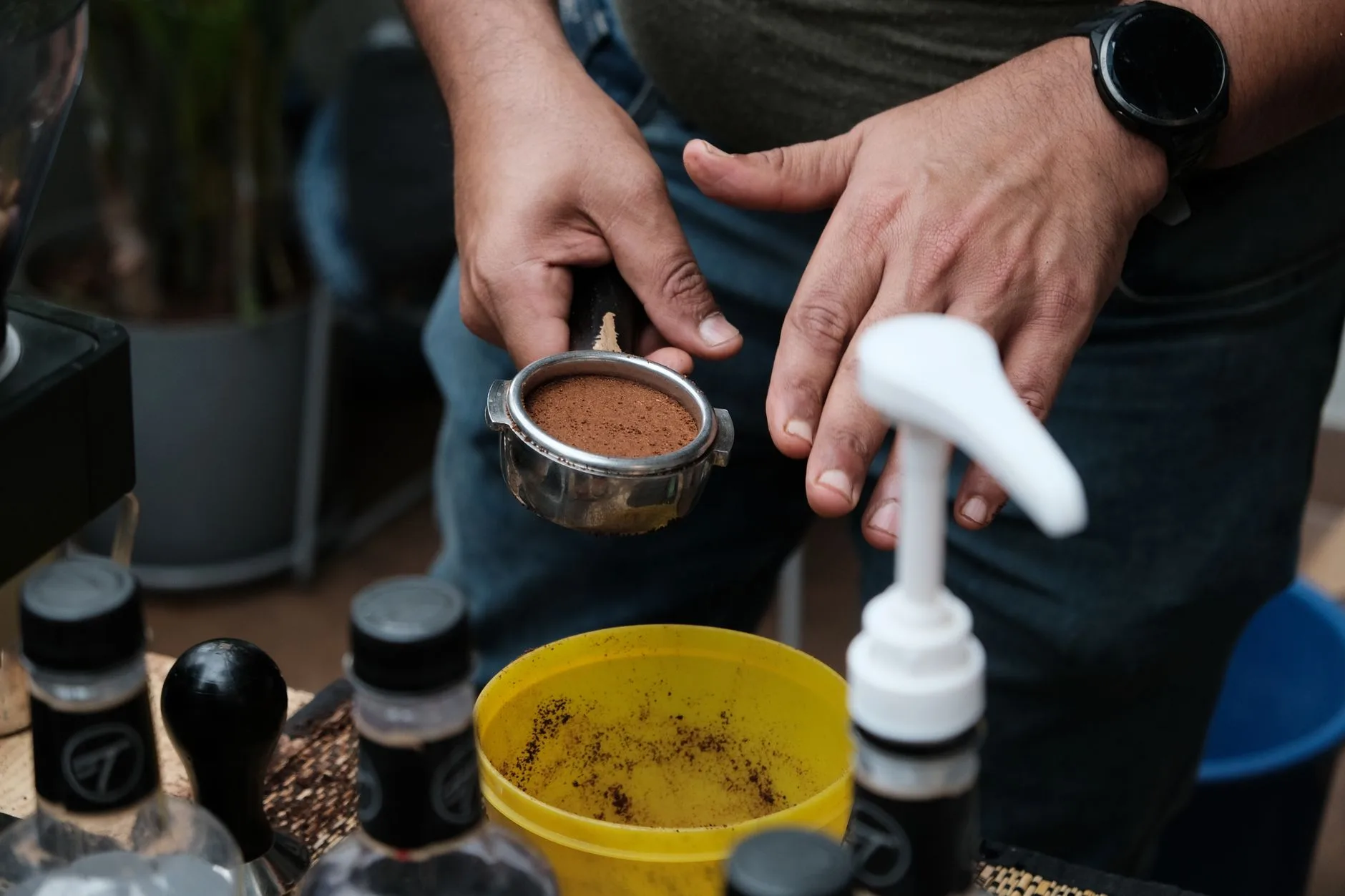 Barista preparing an espresso puck in a portafilter