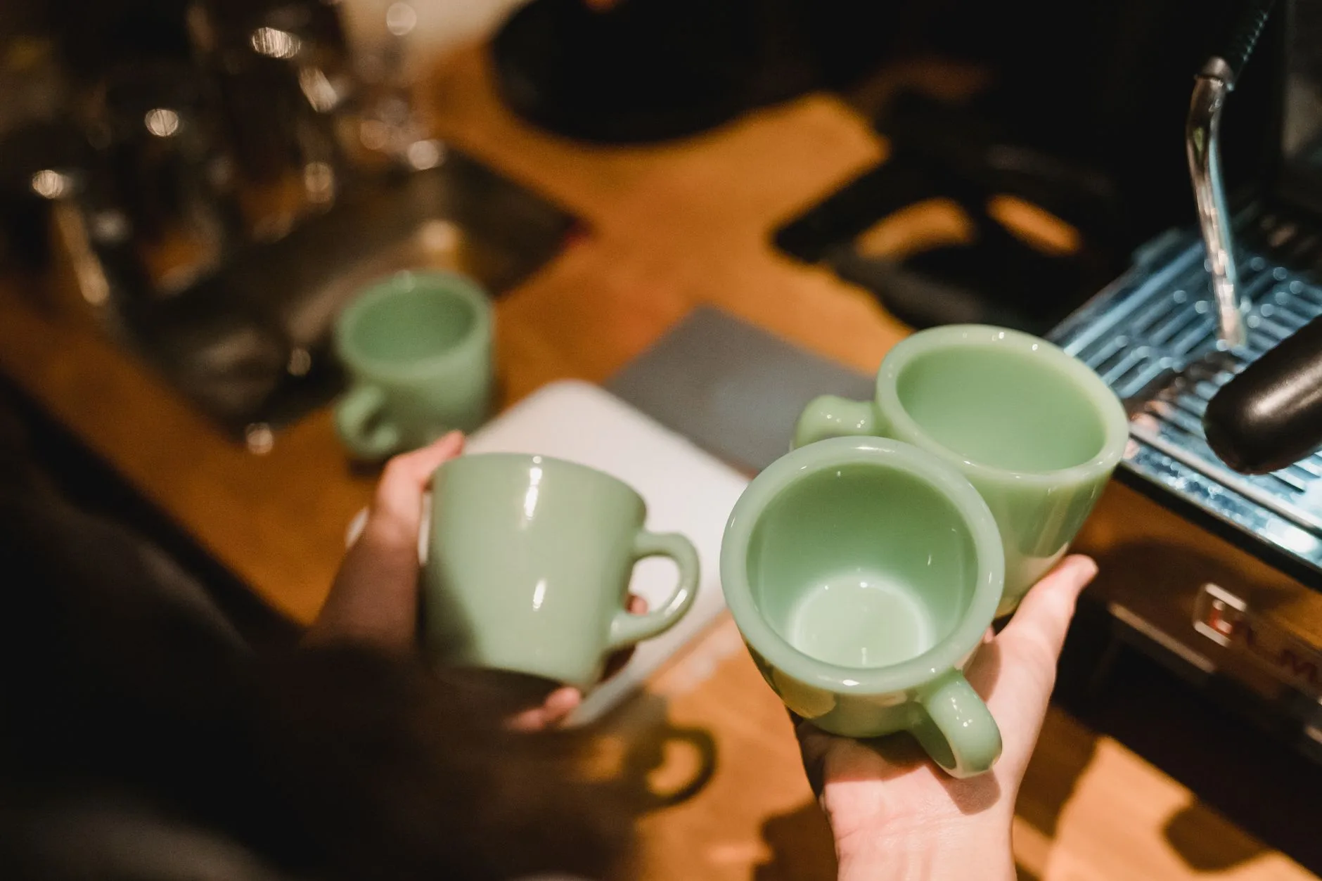 Home coffee setup with ceramic mugs and espresso cups